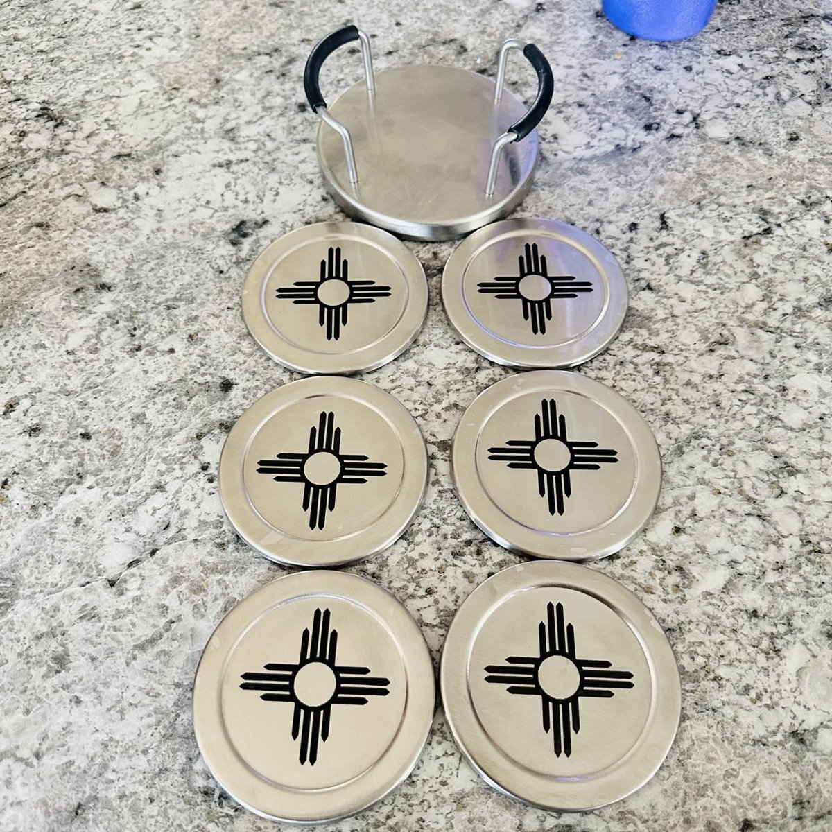 Set of six stainless steel coasters with a Zia symbol and a holder, by KB Custom Creations