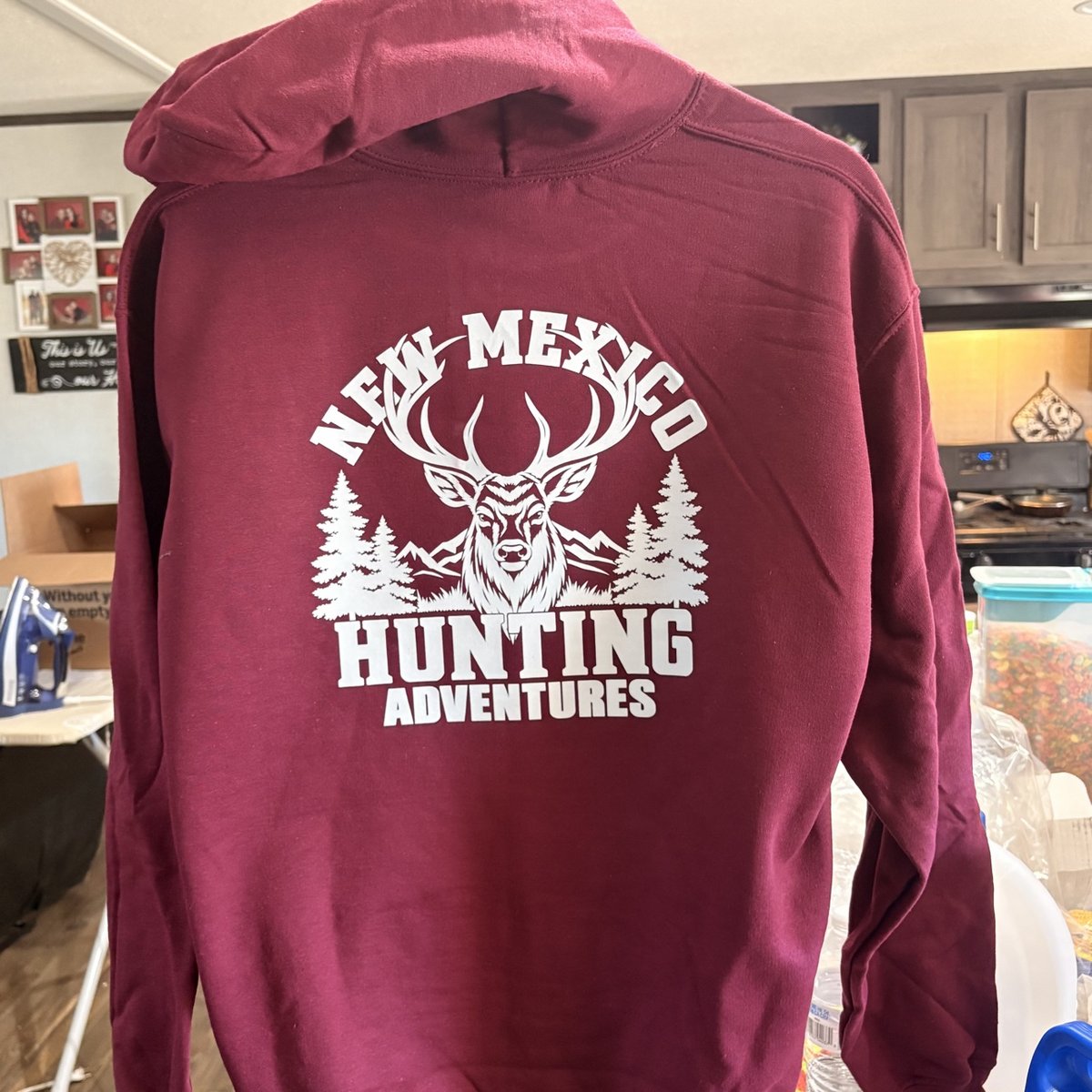 Maroon hoodie with the New Mexico Hunting Adventures design in white on the back, made by KB Custom Creations
