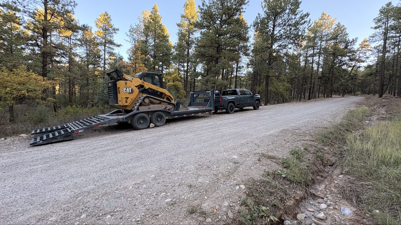 BK Hauling truck and trailer on the road to a job