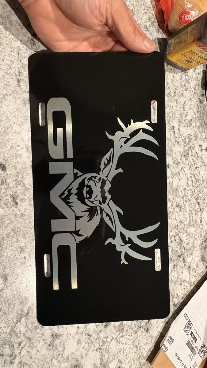 Black license plate engraved with an elk head design by KB Custom Creations