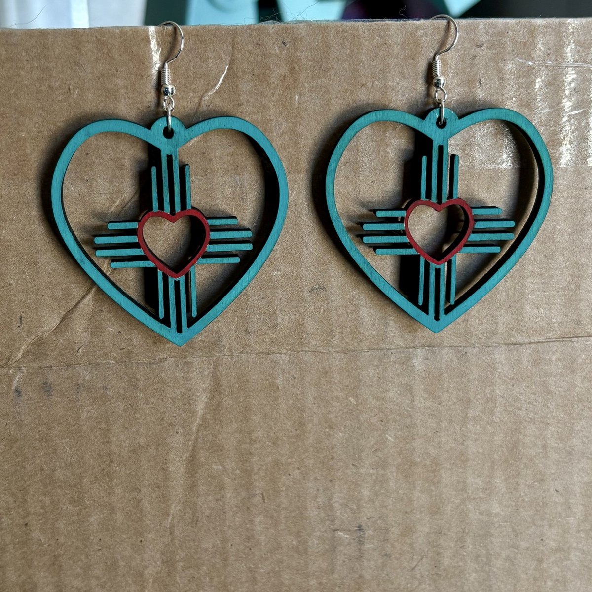 Turquoise wood heart earrings with a Zia symbol and red heart center, by KB Custom Creations