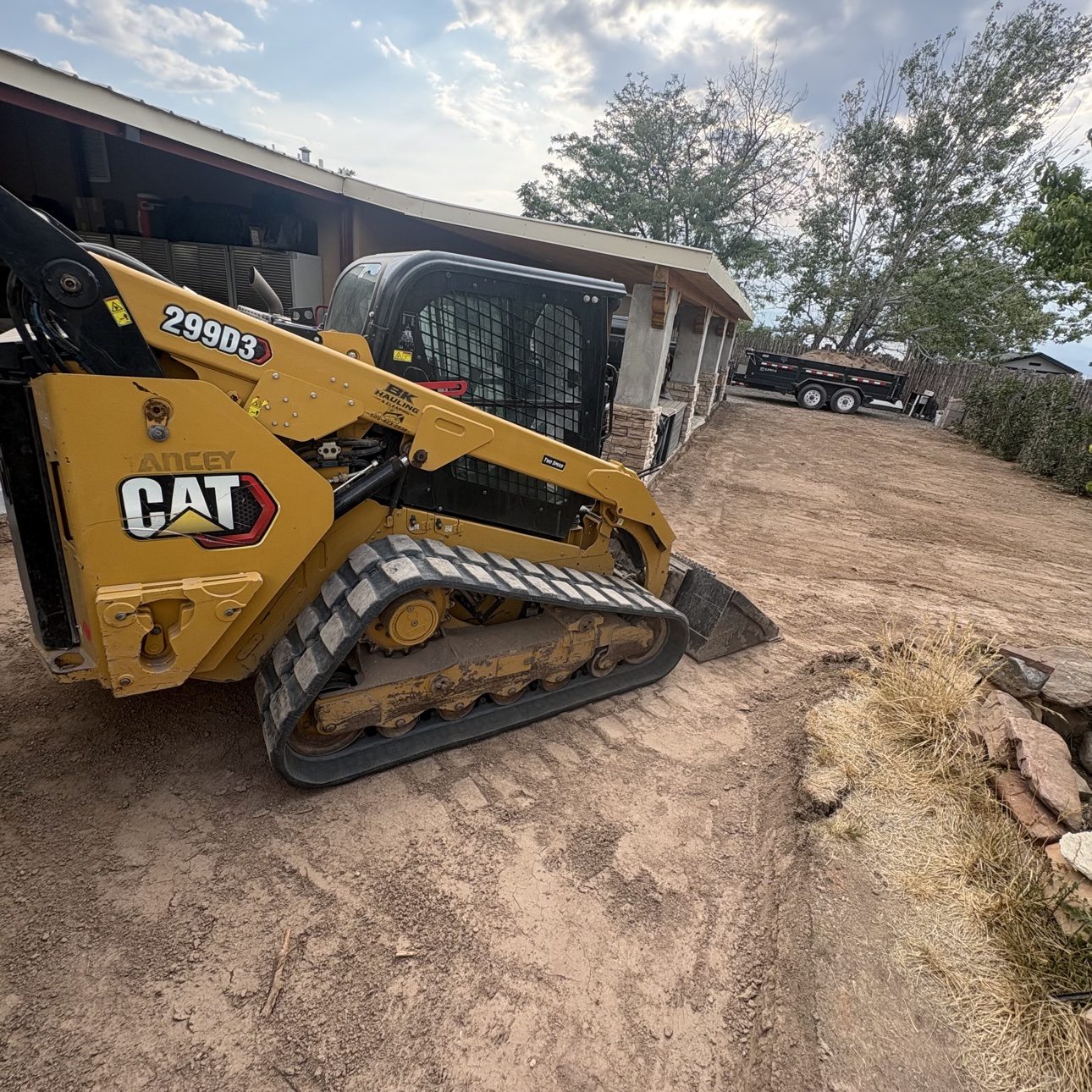 BK Hauling & Clearing's CAT 299D3 skid steer on a job site in New Mexico
