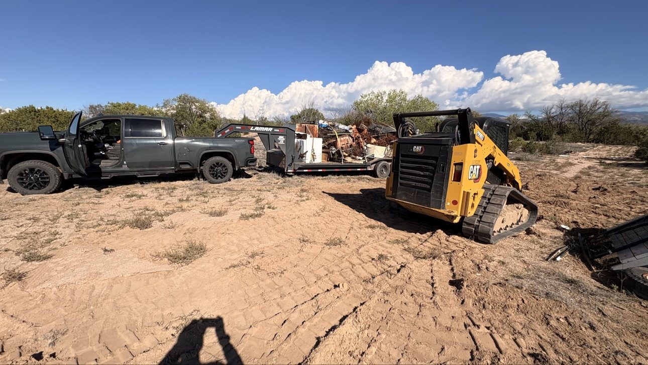 Truck and trailer loaded with junk ready to haul away